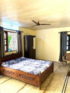 a bed in a room with a ceiling at Virens Heaven Stays in Calangute +9 photos