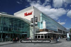 a large building with a sign in front of it at Abbey Hotel, London Shepherd's Bush in London