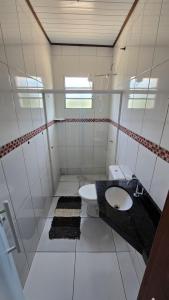 a bathroom with a toilet and a sink at Pousada Colibri in Trindade
