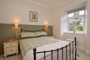 a bedroom with a bed and a window at Seascape in Kames