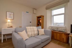 a living room with a couch and a window at Seascape in Kames +12 photos