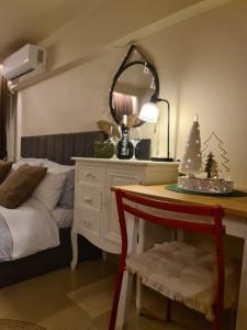 a bedroom with a bed and a table with a christmas tree at 48 Central Nest in Volos