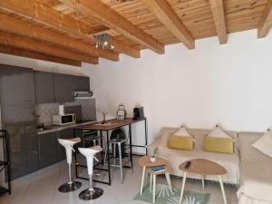 a living room with a couch and a table at Les Chênes Verts in Corte