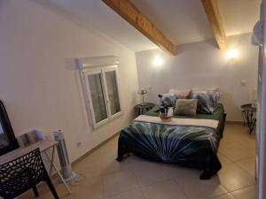 a bedroom with a bed and a window at Les Chênes Verts in Corte