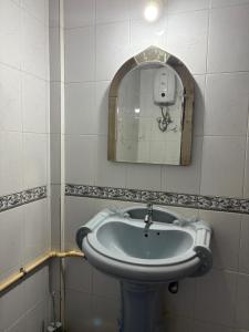 a bathroom with a sink and a mirror at Virens Heaven Stays in Calangute