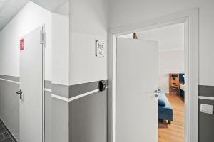 a hallway with a glass door and a living room at Mivano Apartments - Allergarten in Celle