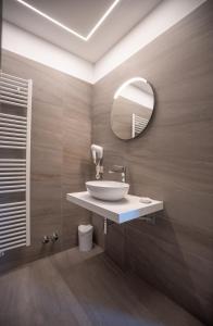 a bathroom with a sink and a mirror at Albergo Silvana in Ledro +55 photos