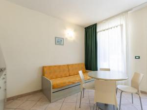 a living room with a couch and a table at Apartment Borgoverde-5 by Interhome in Imperia