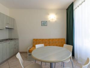 a kitchen and a table and chairs in a room at Apartment Borgoverde-5 by Interhome in Imperia +28 photos