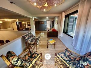 a living room with couches and a table at Canto das Praias - Florianópolis/SC in Florianópolis +36 photos