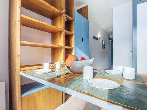 a kitchen with a counter with plates on it at Studio Les Olympiades-28 by Interhome in Val Thorens