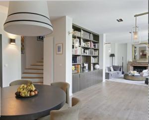 a dining room and living room with a table and chairs at Les Jardins du Panthéon in Paris