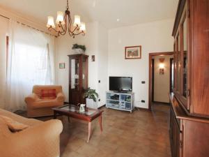 a living room with a couch and a tv at Villa Patrizia by Interhome in Forte dei Marmi