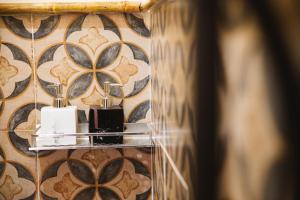 a bathroom with two candles on a wall at Ruby's Home- Doc Let's House in Ngân Hà +71 photos