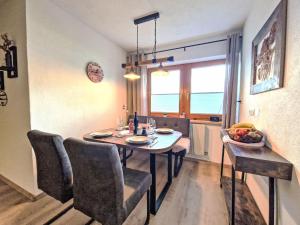 a dining room with a table and chairs and a window at Apartment August by Interhome in Schlitters +17 photos