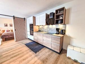 a kitchen with a sink and a bed in a room at Apartment August by Interhome in Schlitters