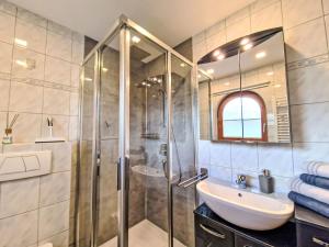 a bathroom with a shower and a sink at Apartment August by Interhome in Schlitters