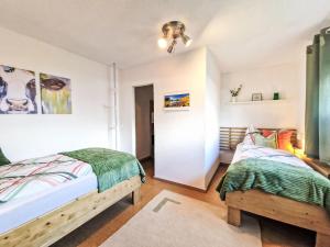 a bedroom with two beds and a closet at Apartment August by Interhome in Schlitters