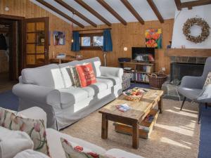 a living room with a white couch and a table at Chalet 5 Ecorces by Interhome in Verbier