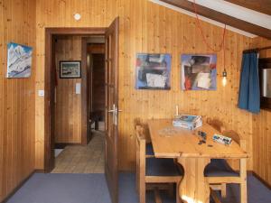 a wooden room with a wooden table and a hallway at Chalet 5 Ecorces by Interhome in Verbier +33 photos