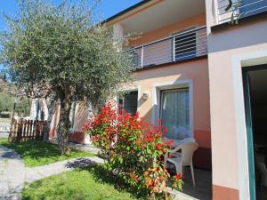 a house with a table and a tree in the yard at Studio Borgoverde-12 by Interhome in Imperia
