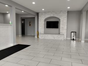 a large room with a flat screen tv on a wall at Super 8 by Wyndham Morris in Morris