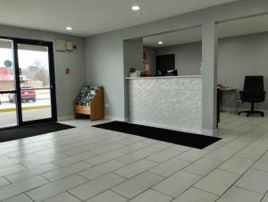 an empty office with a lobby with a counter at Super 8 by Wyndham Morris in Morris