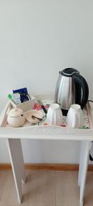 a white table with a tea pot and dishes on it at Le Clos La Perdiz in Pigüé