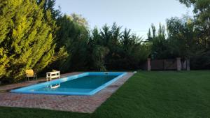 a swimming pool in a yard with a bench next to it at Le Clos La Perdiz in Pigüé