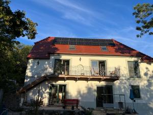 a white house with a roof with a balcony at In the nature in Vroutek