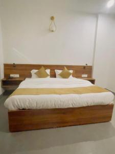 a bedroom with a large bed with white sheets and pillows at MADHUBAN STAYS rishikesh in Rishīkesh +4 photos