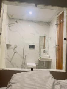 a white bathroom with a sink and a mirror at MADHUBAN STAYS rishikesh in Rishīkesh