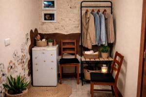 a room with a clothes rack and chairs at Dimora delle Badesse in Conversano