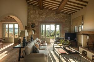 a living room with a couch and a table at Castello di Casole, A Belmond Hotel, Tuscany in Casole dʼElsa