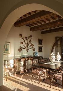 a dining room with a table and chairs at Castello di Casole, A Belmond Hotel, Tuscany in Casole dʼElsa