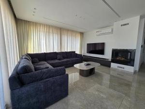 a living room with a couch and a fireplace at Villa rooftop with stunning view apartment in Amman