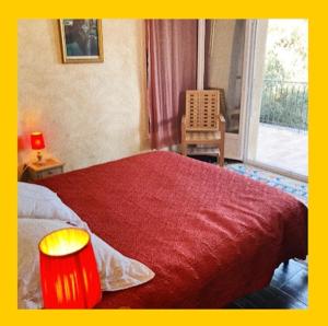 a bedroom with a bed with a red blanket and a window at Villa avec vue et piscine privée in Moltifao +11 photos