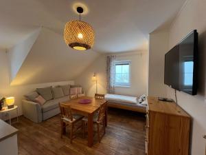 a living room with a couch and a table at Apartment Brusinka in Kašperské Hory