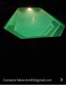 a green glass item on a black background at Villa avec vue et piscine privée in Moltifao
