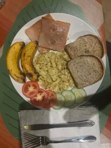 a plate of breakfast food with eggs bread and toast at EL-NARA SEASIDE Beach Resort in El Nido +75 photos