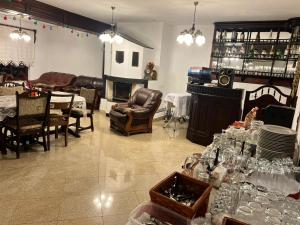 a living room with a table and chairs and a fireplace at Casa De Vis in Arieşeni +23 photos