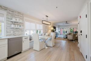 a kitchen and living room with a table and chairs at Coastal Quarters Condo in Bluffton