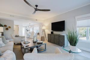 a living room with a couch and a tv at Coastal Quarters Condo in Bluffton
