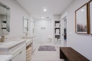 a white bathroom with two sinks and a mirror at Coastal Quarters Condo in Bluffton +32 photos