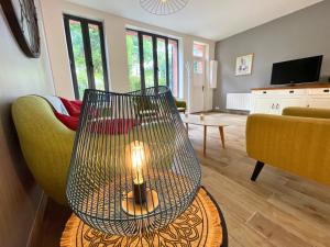 a living room with a chair and a table at Villa LES MYRTILLES in Cabourg