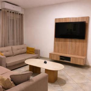 a living room with a couch and a table at Kokoloko in Ambatoloaka