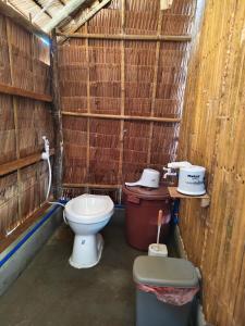 a small bathroom with a toilet and a sink at EL-NARA SEASIDE Beach Resort in El Nido