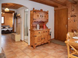 a kitchen with a wooden cabinet in a room at Chalet Mélèze 1967 by Interhome in Ovronnaz +27 photos