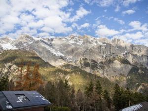 a view of a mountain range with trees and a building at Chalet Mélèze 1967 by Interhome in Ovronnaz