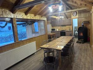 a dining room with a long table and chairs at Casa Moșoiu in Bran